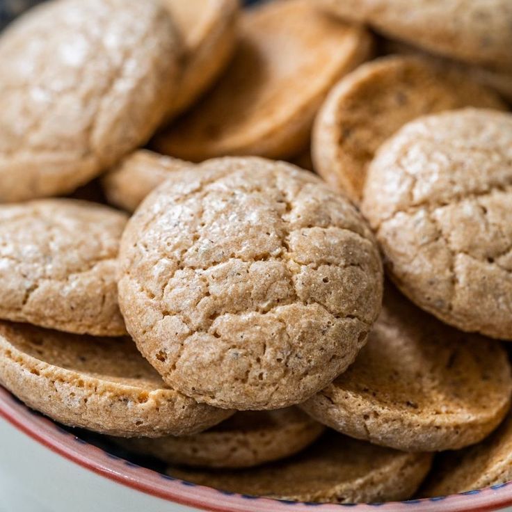 a bowl filled with cookies sitting on top of a table