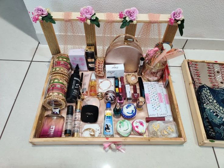 two wooden trays filled with different types of cosmetics and personal care items on top of a tiled floor