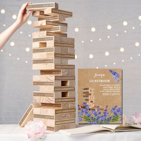 a stack of wooden blocks sitting on top of a table next to an open book