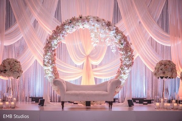 a white couch sitting under a wedding arch