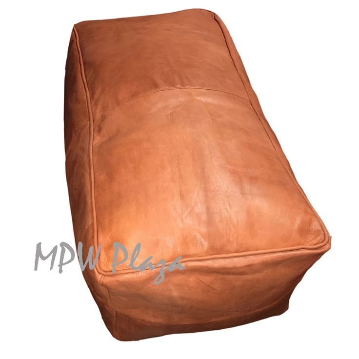 a brown leather footstool is shown with the word mmplag on it