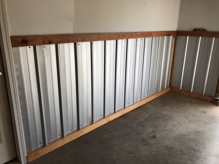 an empty room with metal panels on the wall