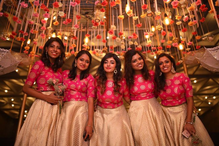 the bridesmaids are all dressed in pink and gold outfits for their big day