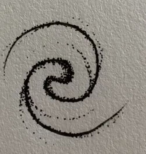 the letter s is drawn in black ink on a white paper with a circular design