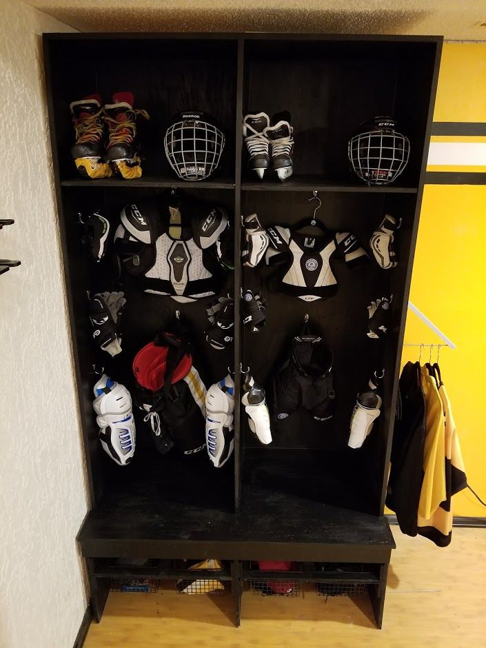 a black shelf filled with lots of hockey gear