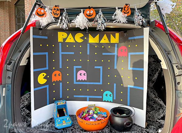 a pacman game is displayed in the trunk of a car with decorations on it