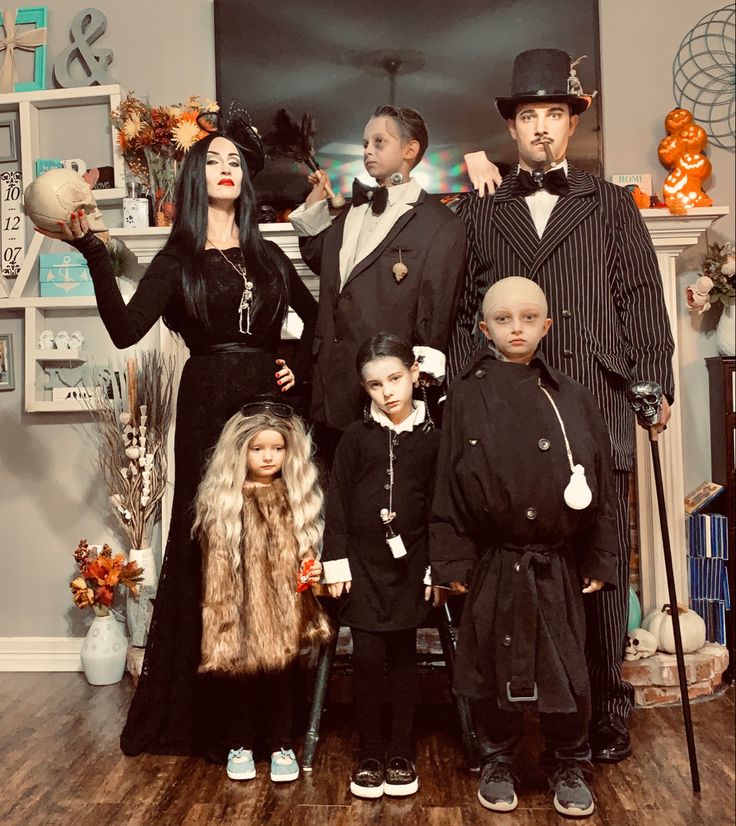 Addams Family halloween costumes. Actually the Roessner’s! Hand made halloween costumes from finds at good will. DIY Costume ideas every year from the Roessner family of 6. Mom sews all the costumes! What will they think of next? Amazing halloween costume ideas. Morticia, Gomez, Uncle Fester, Lurch, Wednesday, Cousin It. All makeup done by Mom Emily as well. Awesome group of people Adams Family Costume Family Of 5, Scary Halloween Costume Ideas Group, Family Of 4 Costumes Halloween, Diy Addams Family Costume, Family 6 Halloween Costumes, Lurch Costume Diy, Wednesday Family Costume, Wednesday Addams Mom, Halloween Family Custom Ideas