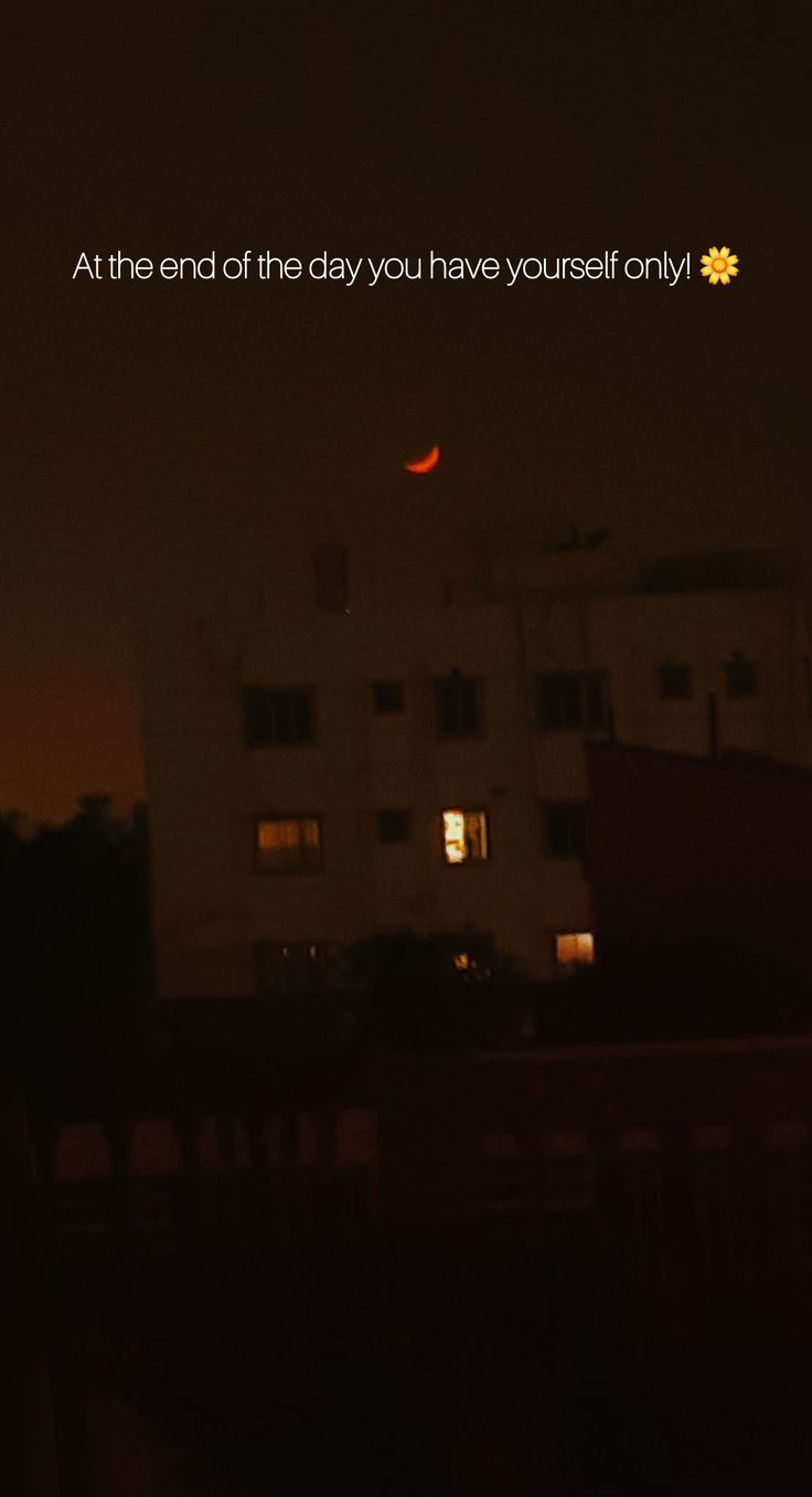 an image of a building at night with the moon in the sky and words above it