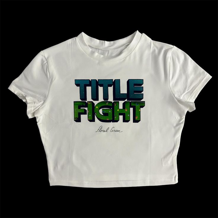 * Sublimated Title Fight band floral green cropped baby tee * Mannequin is wearing size XL * Mannequin measurements:    * Bust: 35" (C cup)    * Waist: 26"    * Hip: 40" * Soft, breathable, and stretchy material * For a looser fit, size up * Please note that all items are Made to Order & there may be slight variations in appearance Grunge Cropped T-shirt With Letter Print For Streetwear, Fitted Green Crop Top T-shirt, Fitted Cropped T-shirt For Streetwear, Green Fitted Crop Top T-shirt, Summer Band Merch Cropped T-shirt With Graphic Print, Y2k Green Tops For Streetwear, Y2k Green Top For Streetwear, Green Y2k Style Top For Streetwear, Trendy Green T-shirt With Graffiti Print