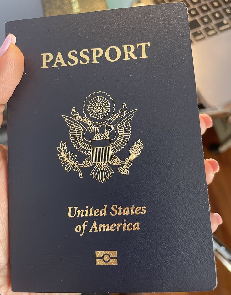 a person holding an american passport in their hand