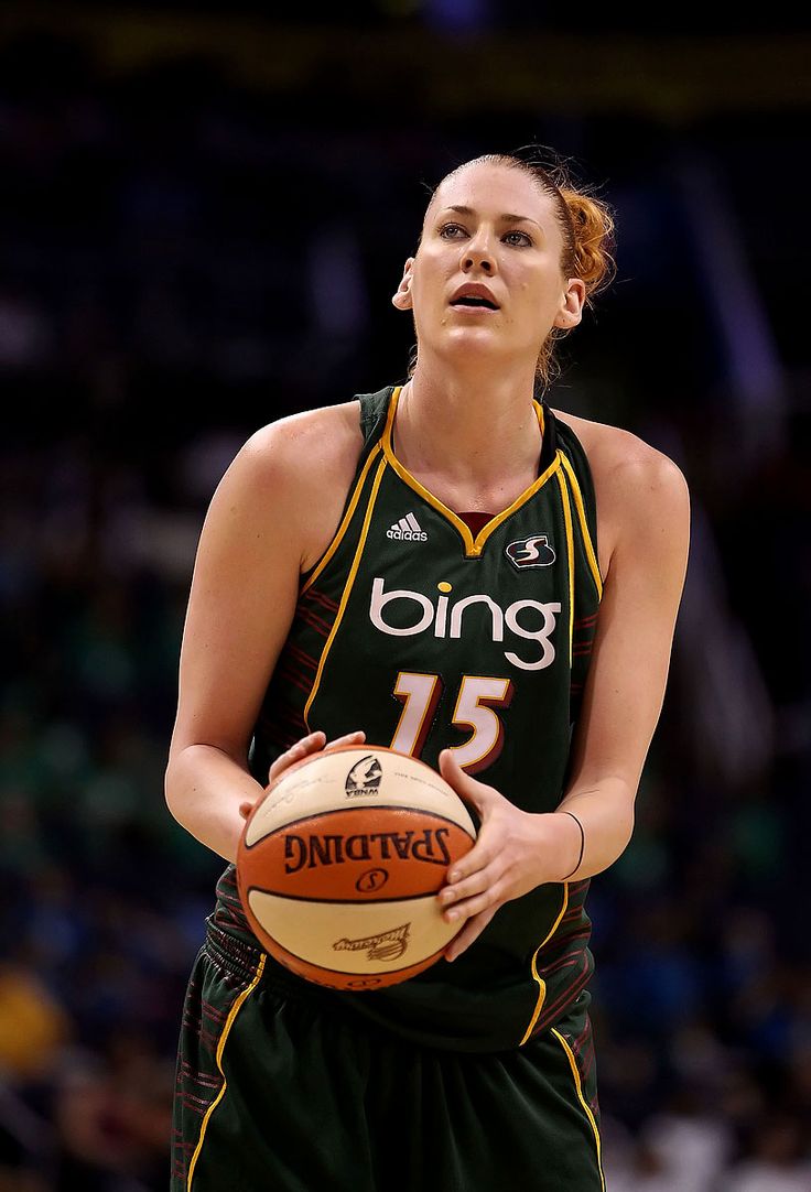 a woman holding a basketball in her right hand