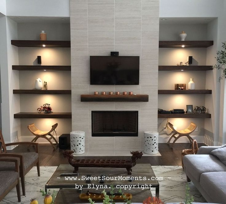 a living room filled with furniture and a flat screen tv mounted on the wall above a fireplace