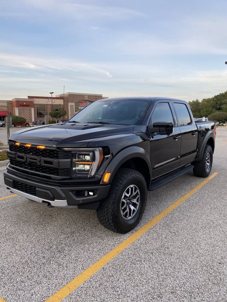 a black pickup truck parked in a parking lot