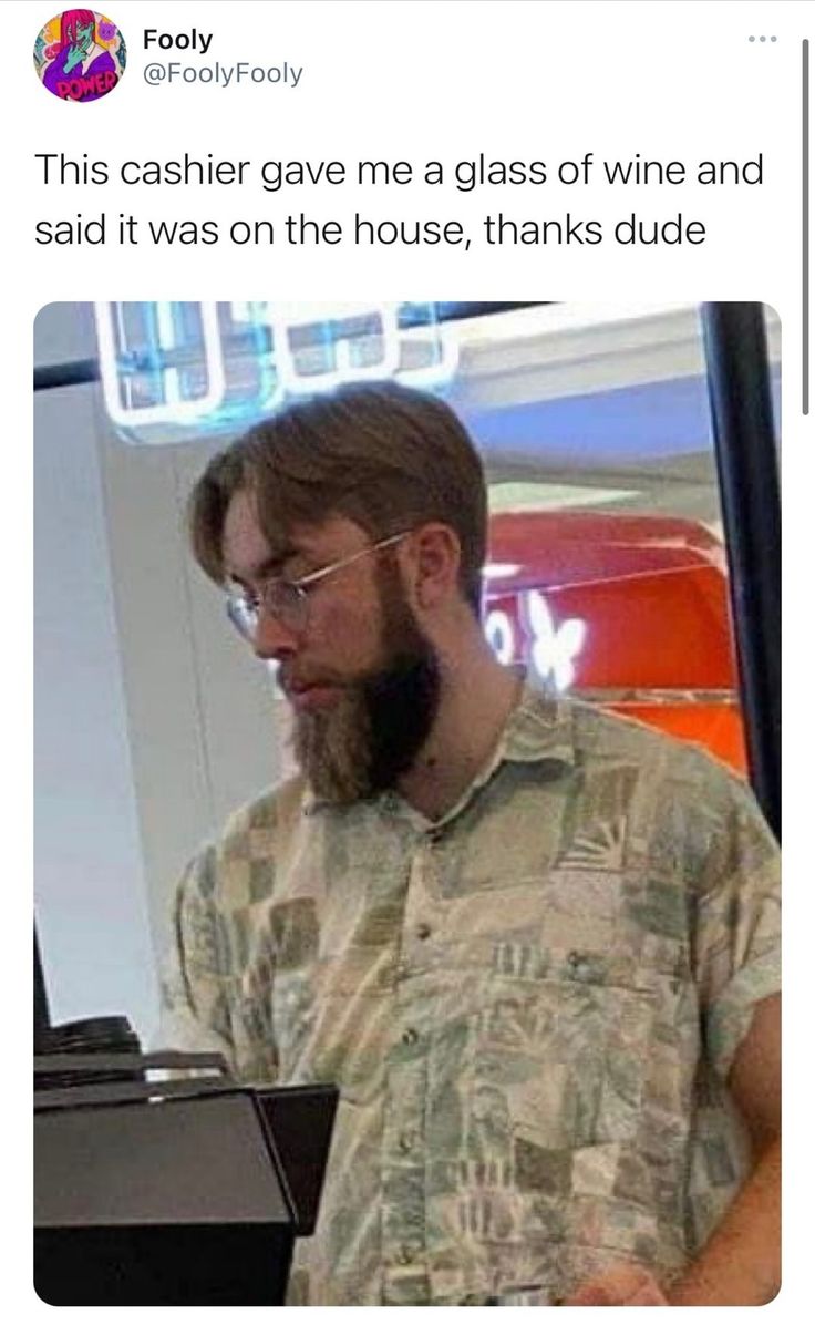 a man with glasses and a beard is looking at a computer screen that says, this cashier gave me a glass of wine and said it was on the house, thanks dude