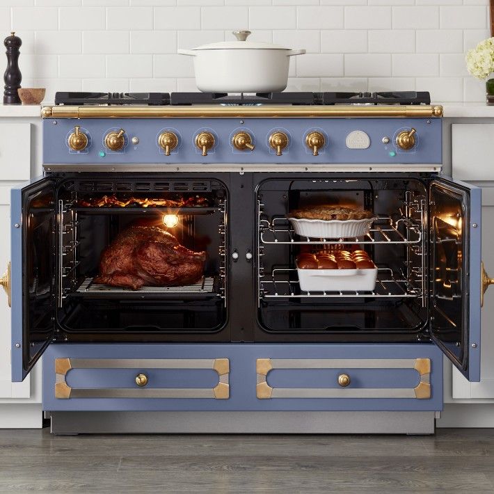 an oven with two roasting pans in it