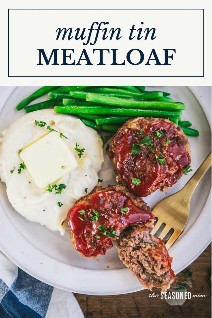 two meatloaf muffins on a plate with mashed potatoes and green beans