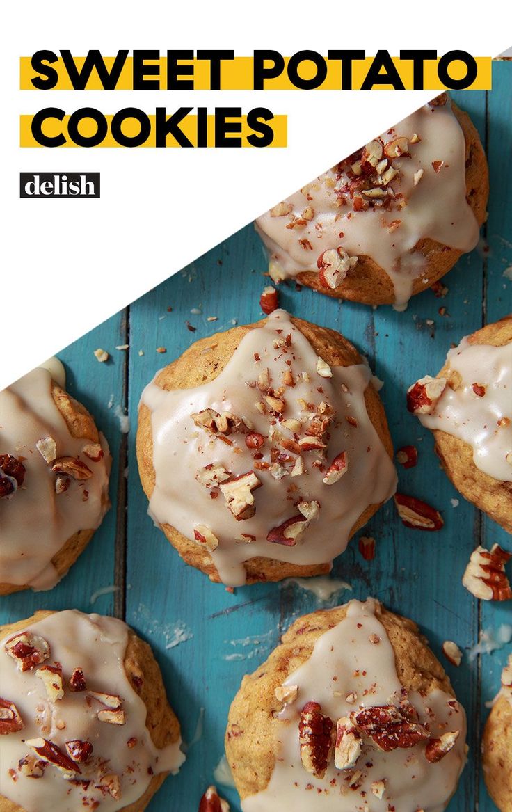 sweet potato cookies with white icing and pecans on a blue wooden table top