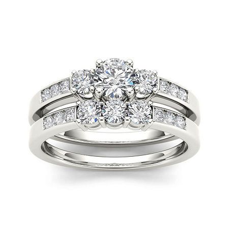 a white gold engagement ring set with two matching bands and a round diamond center stone