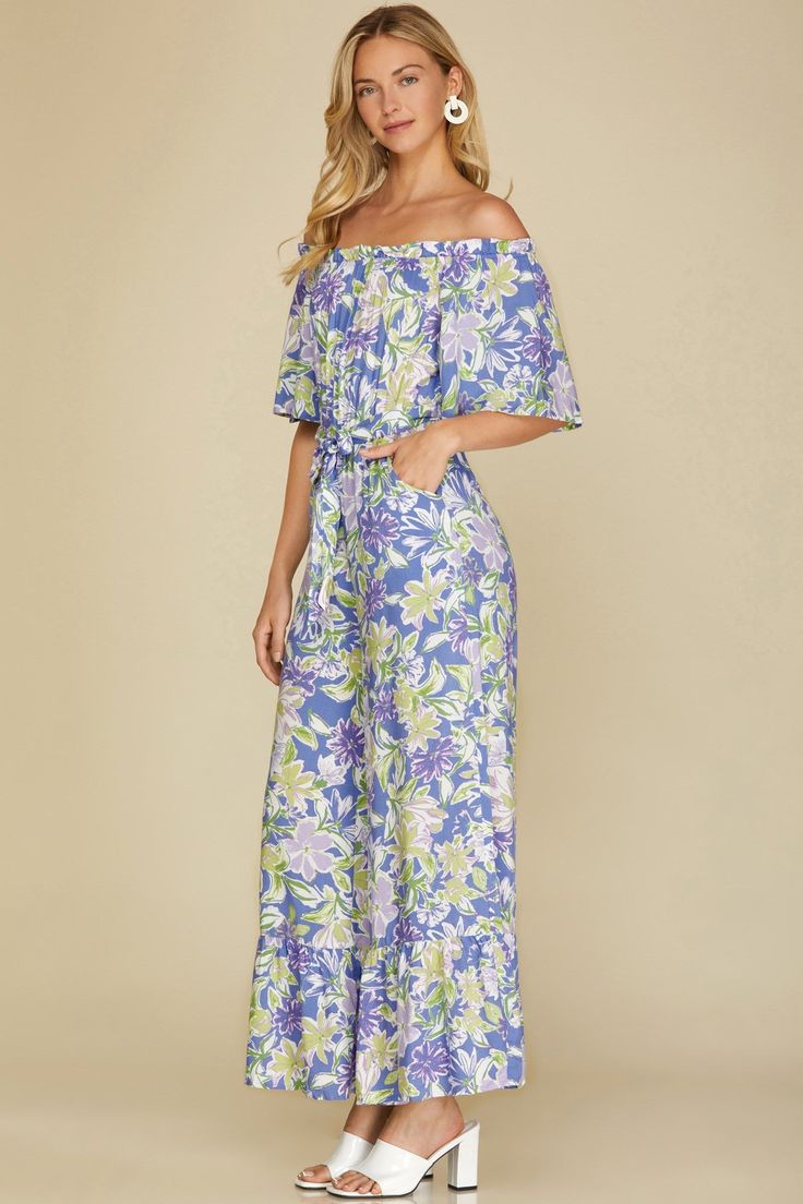 She + SkyCute tropical woven lined jumpsuit, loose fitting flowy style. Ruffle accented, waist sash tie belt. This jumpsuit is sure to make a lasting impression, with its timeless feminine design and eye-catching colors. The adjustable waist-tie belt ensures a perfect fit that won’t sag or slide out of place.Color: Violet BlueSizes: S-M-LModel is 5' 10"100% Rayon, Lining 100% Polyester, importedC2/SY4921 Belted Jumpsuits And Rompers For Spring Vacation, Summer Vacation Jumpsuits And Rompers With Belt, Beachwear Jumpsuits And Rompers With Tie Waist, Beachwear Jumpsuits And Rompers With Tie Waist For Vacation, Blue Belted Jumpsuit For Summer, Flowy Summer Jumpsuits And Rompers For Brunch, Summer Flowy Jumpsuits And Rompers For Brunch, Chic Vacation Jumpsuits And Rompers With Tie Waist, Spring Jumpsuits And Rompers With Tie Waist