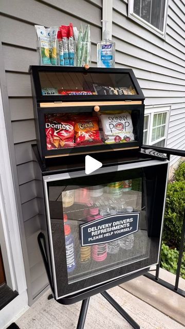 an open cooler sitting on top of a tripod in front of a house next to a door