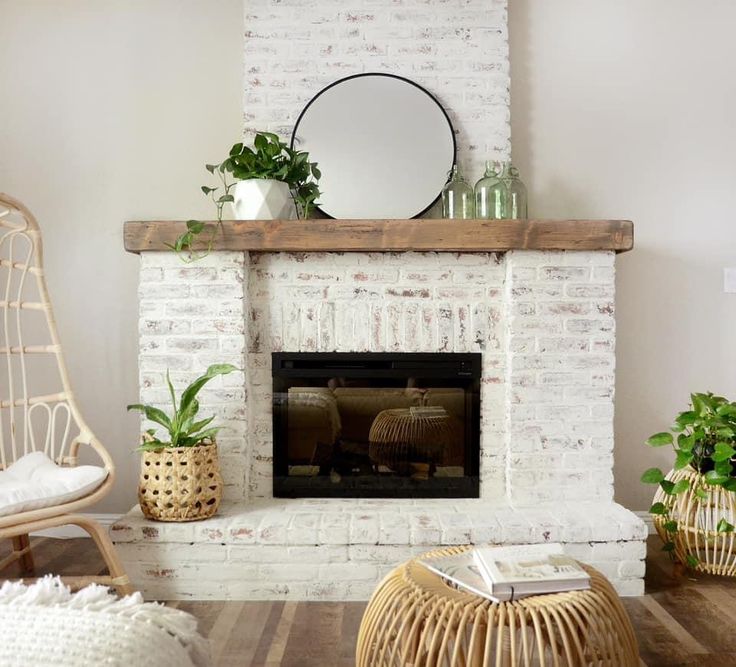 a living room with a white brick fireplace and potted plants