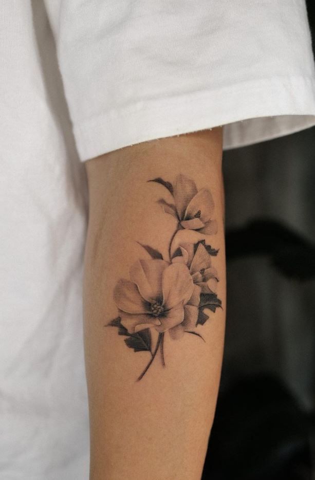 a black and white photo of a flower on the left side of the arm,