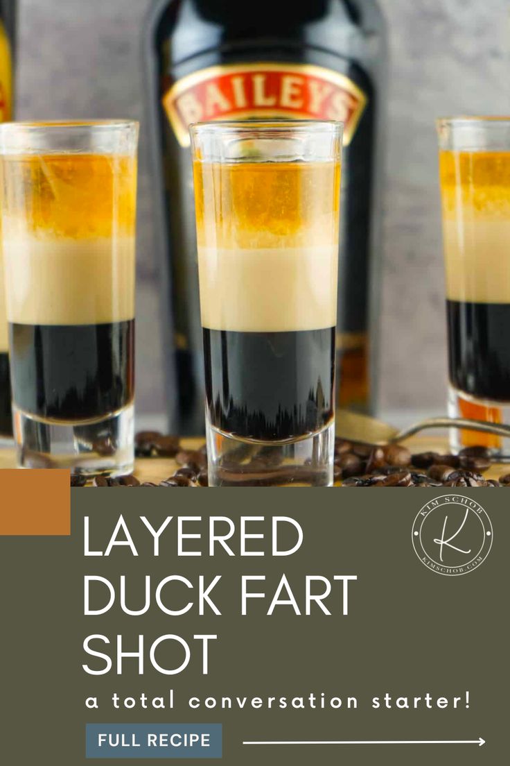 layered duck fart shot in glasses with coffee beans on the table next to it