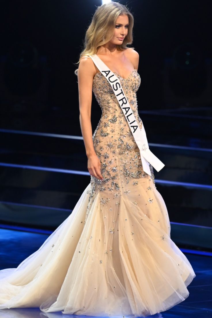 a beautiful woman in a gown on the runway