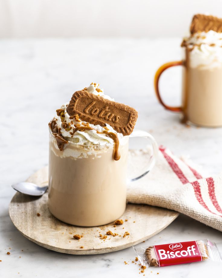 two mugs filled with hot chocolate and whipped cream