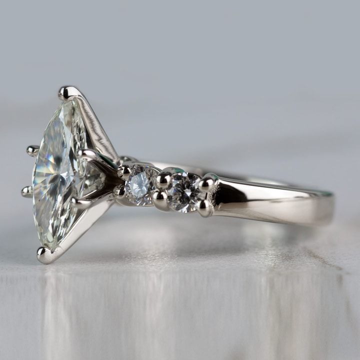 a close up view of a diamond ring with three stones on the bottom and side