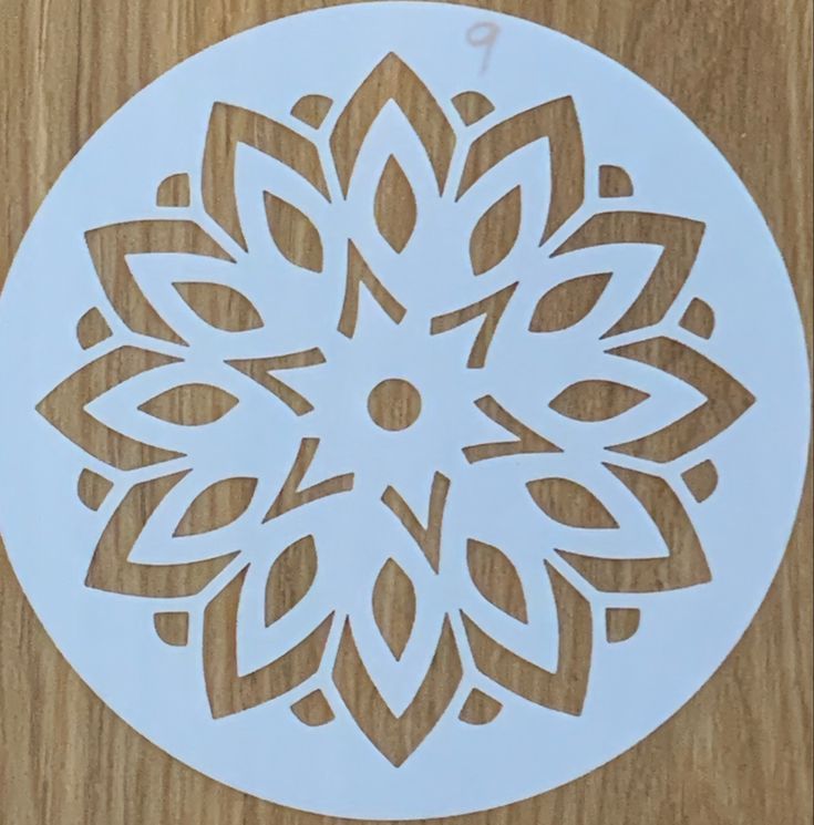 a paper cut out of a flower on top of a wooden table