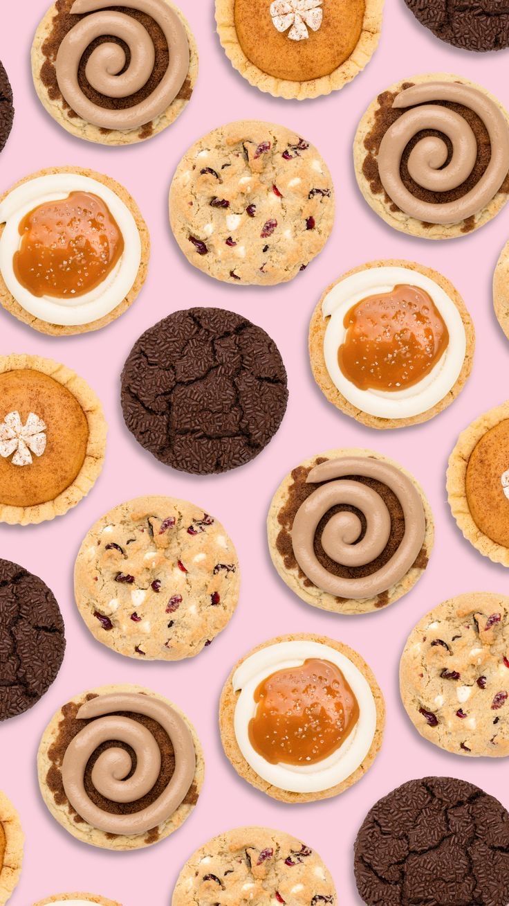 an assortment of cookies and pastries on a pink background