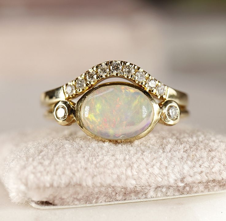 "Minimalist modern 14k yellow gold opal bezel setting ring.  10mm x 7mm oval cabochon genuine Ethiopian opal with 14k solid gold  band and bezel setting. 2 diamonds accented each side.Opal is October birthstone , 14th and 18th Anniversary gemstone. Opal is often associated with inspiration, passion and love. It's symbolizes faithfulness and confidence. Opal is associated with the Crown Chakra. THIS LISTING ONLY FOR OPAL DIAMOND RING. DETAILS ABOUT THE RING, MATERIAL AND STONES  Band is 14k yello Oval Opal Engagement Ring, Bezel Setting Ring, Opal And Diamond Ring, Opal Diamond Ring, October Birthstone Rings, Opal Engagement Ring, Ethiopian Opal Ring, Bezel Set Ring, Opal Ring Gold