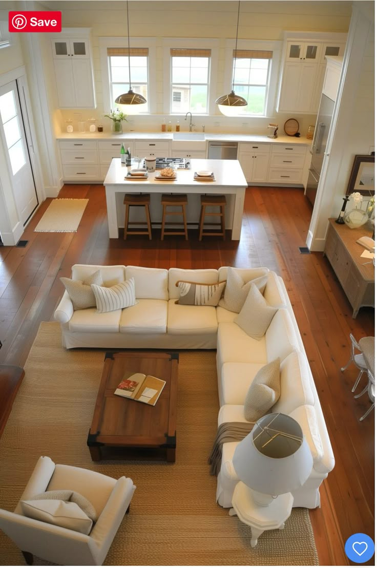 an aerial view of a living room, kitchen and dining area in a house with hardwood floors