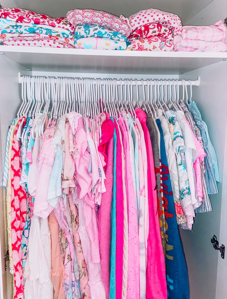 a closet filled with lots of colorful clothes