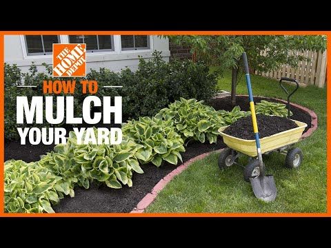 a wheelbarrow filled with dirt and mulch in front of a house that says how to mulch your yard