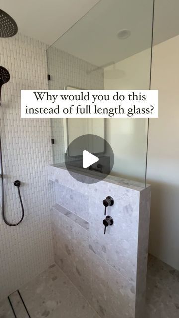 a walk in shower sitting inside of a bathroom next to a sink and shower head