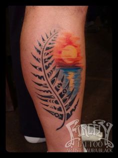 an image of a tattoo on someone's leg with the sun setting in the background