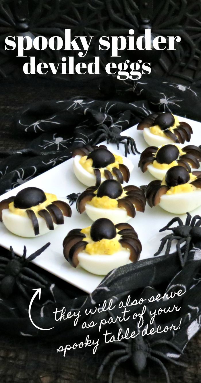 some deviled eggs are on a plate with black spider webs around them and the words spooky spider deviled eggs