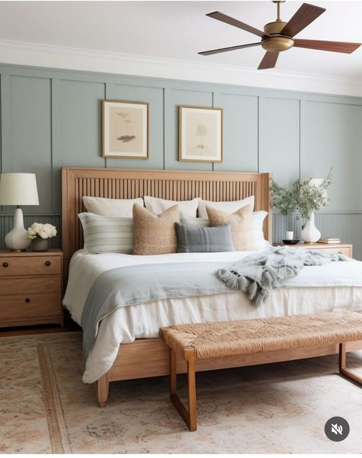 a bedroom with blue walls and white bedding