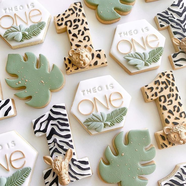 decorated cookies are arranged on a white surface