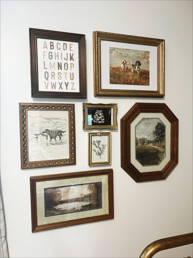 there are many framed pictures on the wall