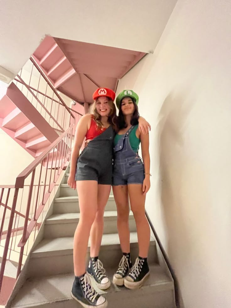 two young women standing on the stairs in front of an umbrella