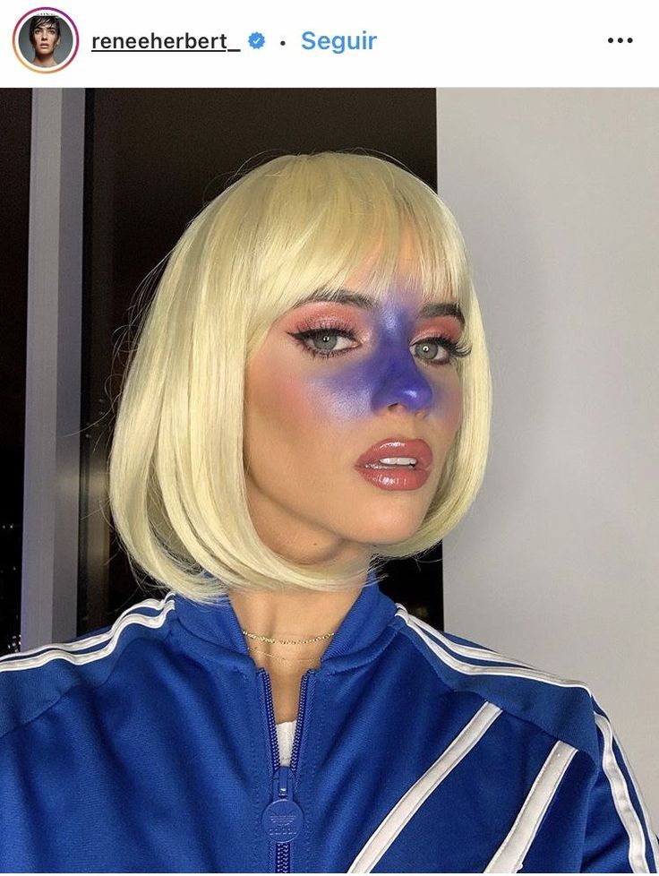 a woman with blonde hair and blue makeup