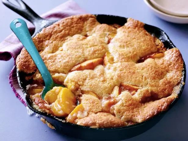 a skillet with some fruit in it on a table