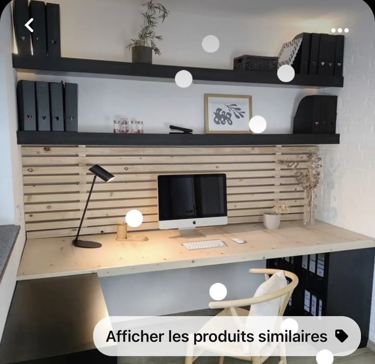 a desk with a chair, computer monitor and bookshelf above it in a room