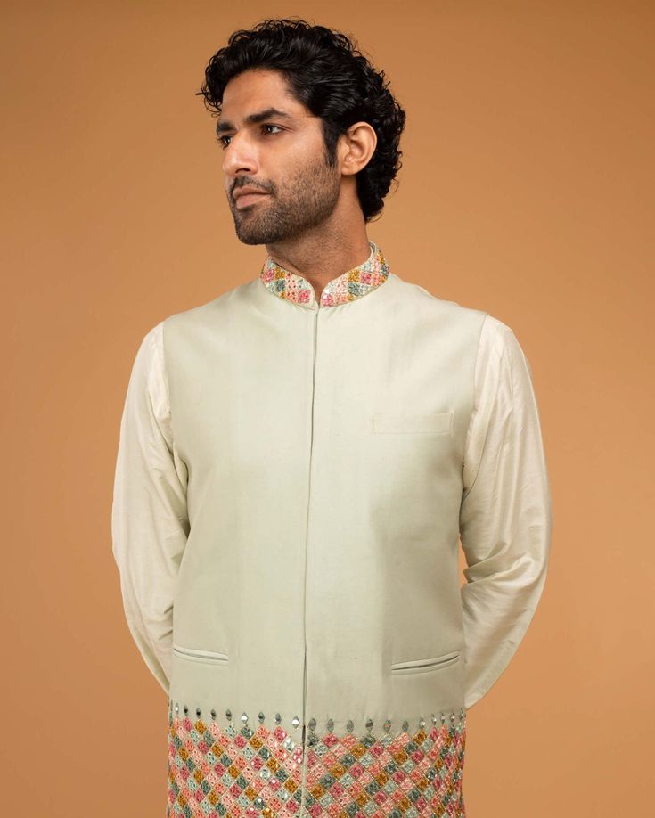 Editor's Note Unleash your unique style with this mint nehru jacket with mirror work and pista kurta. This stunning combination features a refreshing mint nehru jacket adorned with intricate mirror work, paired with a soothing pista green kurta and pants, creating a striking and fashionable outfit for your special events. Fabric: Cotton silk Color: Mint green Components: Kurta, jacket and pants Occasion: Festive Note: Product colour may slightly vary due to photographic lighting sources Care: Dr Luxury Pista Green Nehru Jacket, Spring Cotton Traditional Wear With Mirror Work, Spring Pista Green Kurta With Mirror Work, Spring Traditional Cotton Wear With Mirror Work, Spring Traditional Wear With Mirror Work, Spring Pista Green Traditional Wear With Cutdana, Spring Cotton Nehru Jacket With Zari Work, Spring Nehru Jacket With Zari Work, Straight Kurta Style, Straight Kurta Nehru Jacket With Zari Work For Spring