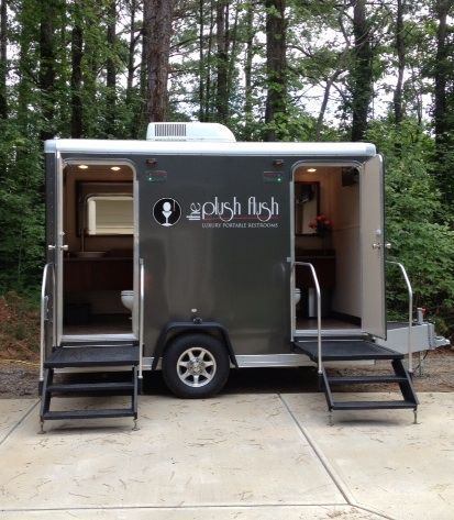 a small trailer parked in the middle of a wooded area with stairs leading up to it