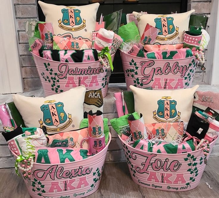 pink and green baskets filled with personal items on top of a wooden floor in front of a fireplace