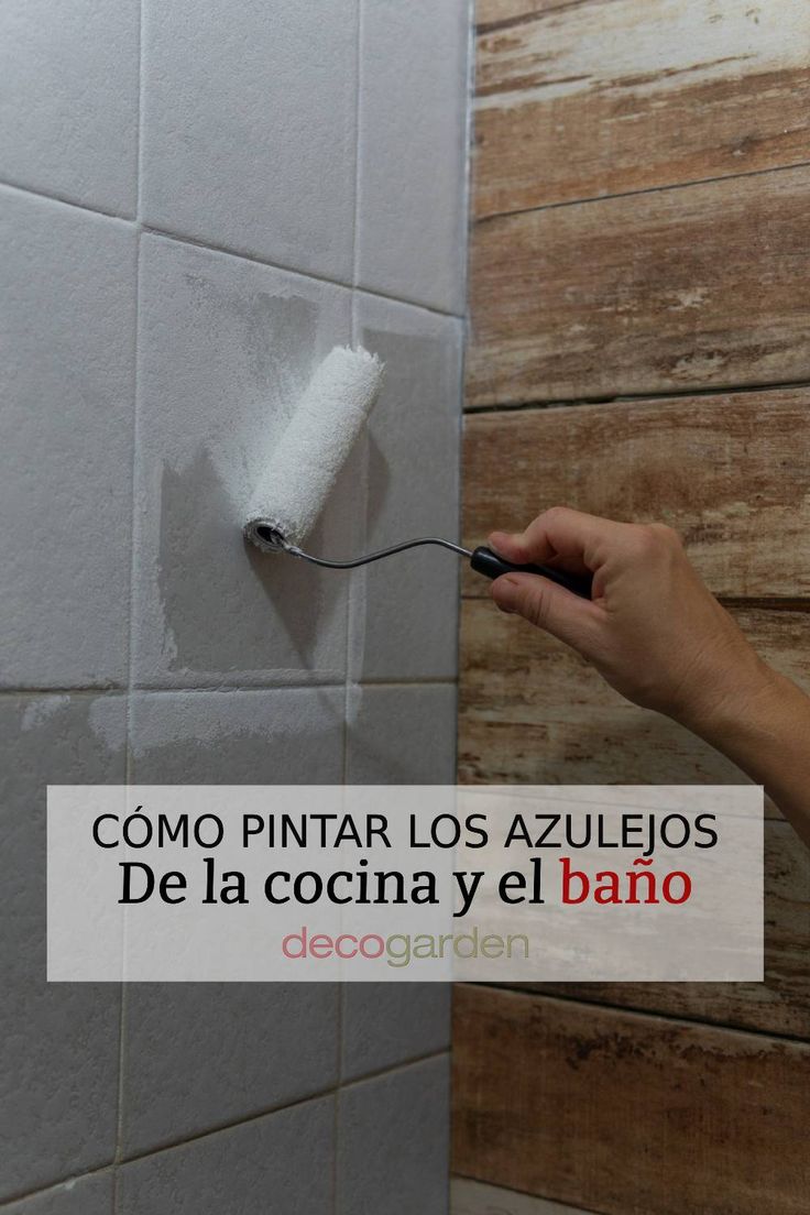 a person is using a brush to paint the wall in a bathroom with wood planks